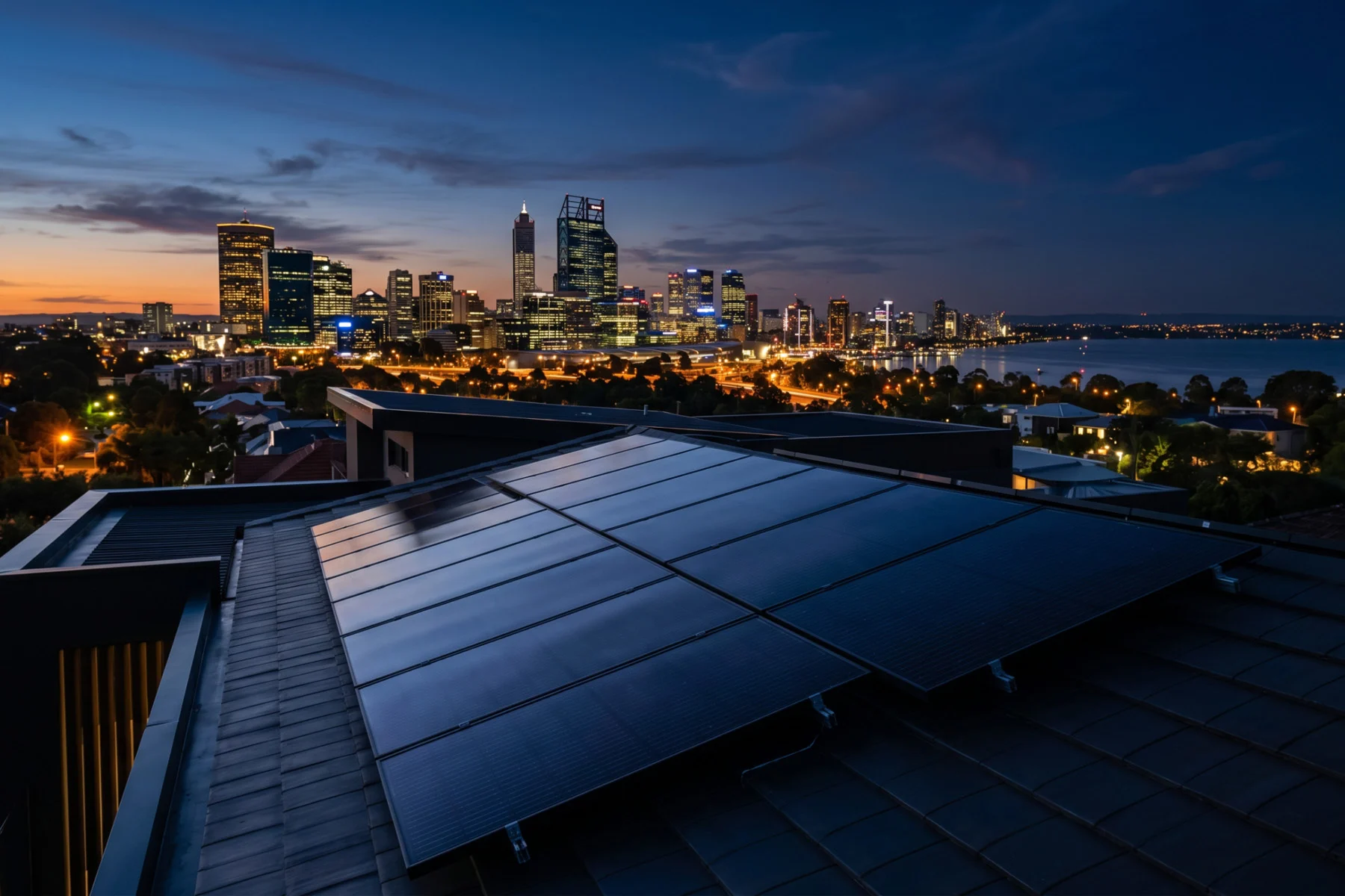Rooftop solar panels with Perth city skyline at dusk